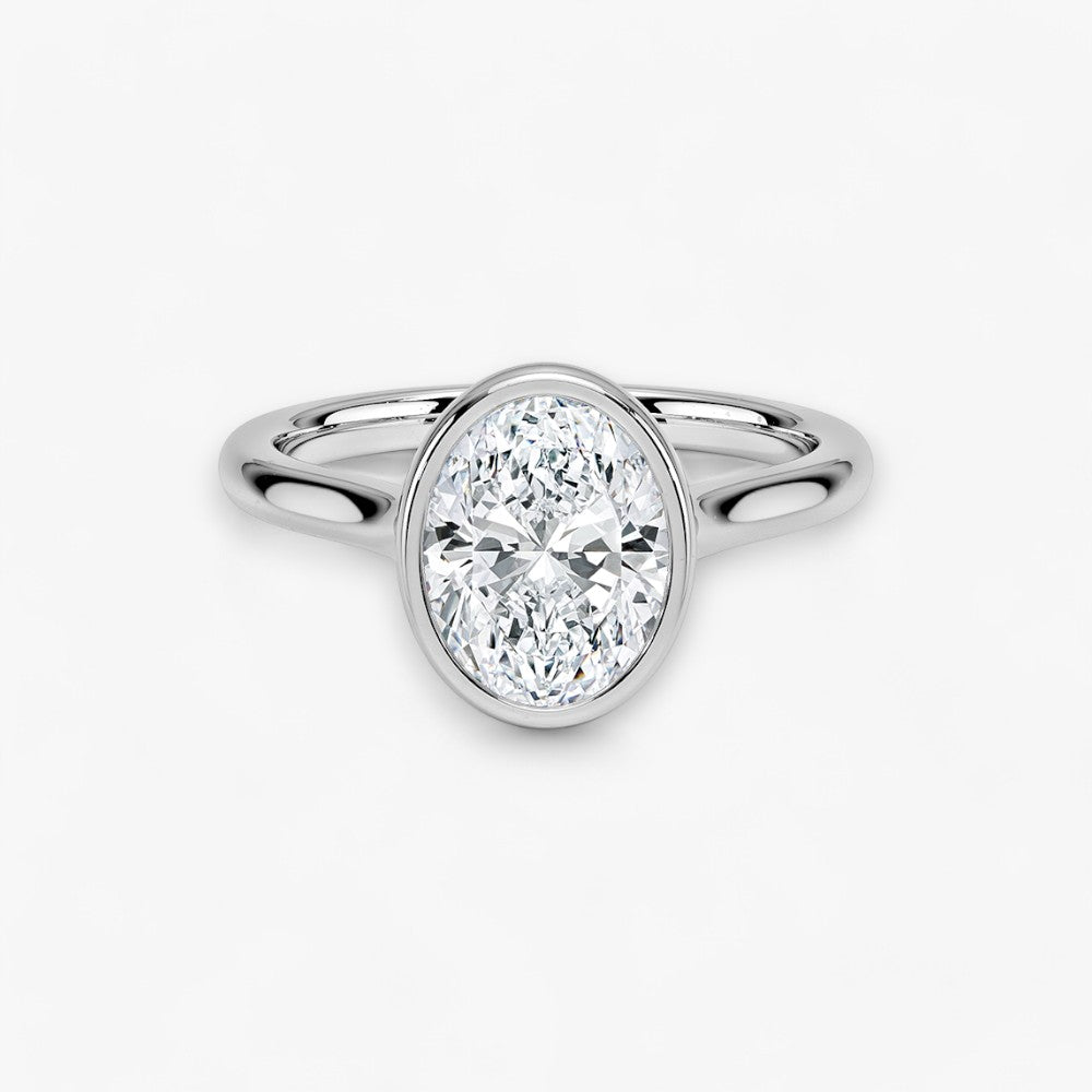 Moderner Verlobungsring mit 2-Karat Oval-Cut-Diamant in einer stilvollen Zargenfassung aus hochwertigem Weissgold. Minimalistisches Schmuckdesign mit luxuriösem Glanz und zeitloser Eleganz, ideal für Verlobung, Hochzeit oder Jubiläum. Exklusiver Diamantring, der Handwerkskunst und modernes Design vereint. Jetzt den perfekten Verlobungsring für besondere Momente online entdecken und kaufen.