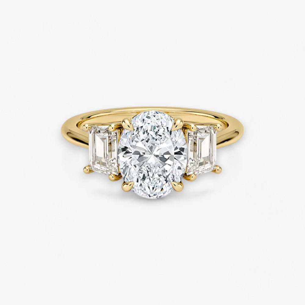 Luxuriöser Verlobungsring mit 2-Karat Oval-Cut-Diamant und seitlichen Emerald-Cut-Diamanten, eingefasst in einer eleganten Gelbgold-Fassung. Exklusiver Diamantring mit brillantem Glanz und moderner Ästhetik, ideal für Verlobung, Hochzeit oder Jubiläum. Hochwertiges Schmuckdesign mit zeitloser Eleganz und handgefertigter Präzision. Perfekter Verlobungsring für besondere Momente. Jetzt online entdecken und bestellen.