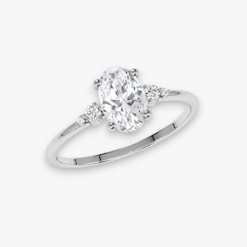 Verlobungsring CASCADE in Weissgold bzw. Platin – ovaler Diamant im Zentrum, flankiert von abgestuften Seitendiamanten